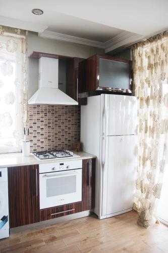 a kitchen with a white refrigerator and a stove at Apartment near the Black Sea Ureki in Ureki