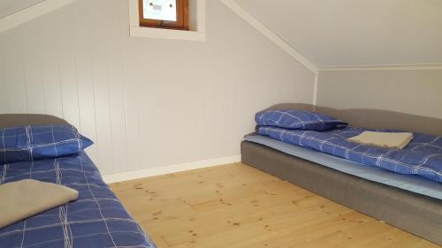 two beds sitting in a room with at Holiday Home Kvernesfjorden in Averoy