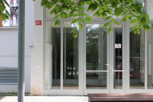 a glass entry door to a building with at Apartment Promenada in Poděbrady