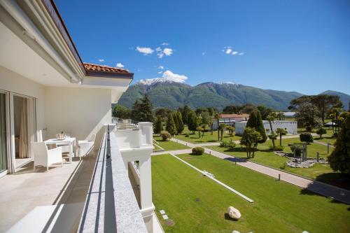 a view from the balcony of a house with a lawn at Delta Resort Apartments in Ascona