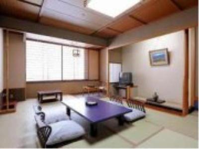 a living room with a table and a couch at Hotel Ohsho in Tendo