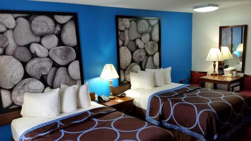 A bed or beds in a room at Super 8 by Wyndham McGehee