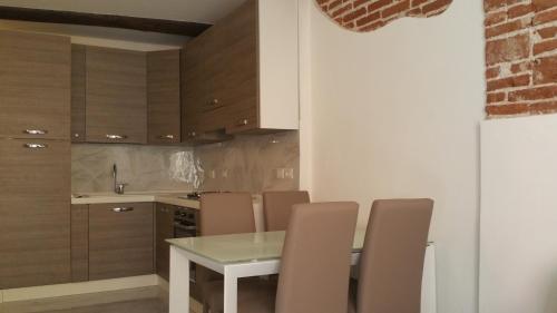 a kitchen with a table and chairs and a sink at La Merlettaia in Rapallo