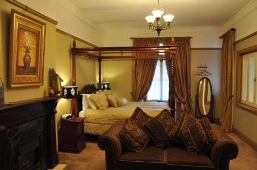 a bedroom with a bed and a couch at Bli Bli House Riverside Retreat in Twin Waters
