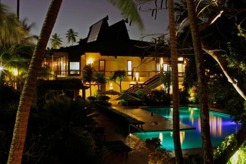 a resort with a swimming pool at night at The Warwick Fiji in Korolevu