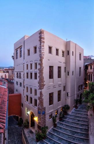 a white building with stairs leading up to it at Porto Del Colombo Traditional Boutique Hotel in Chania Town
