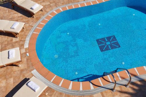 an overhead view of a swimming pool with chairs at Marni Village in Hersonissos