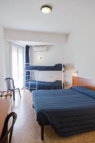 a hotel room with two beds and a window at Hotel Turismo Europa in Casal Borsetti