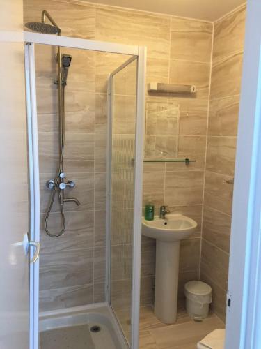 a bathroom with a shower and a sink at Kensington Hotel in Bournemouth
