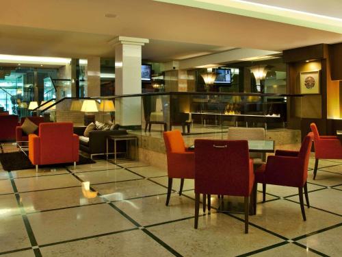 a lobby with chairs and a table in a building at TURIM Iberia Hotel in Lisbon