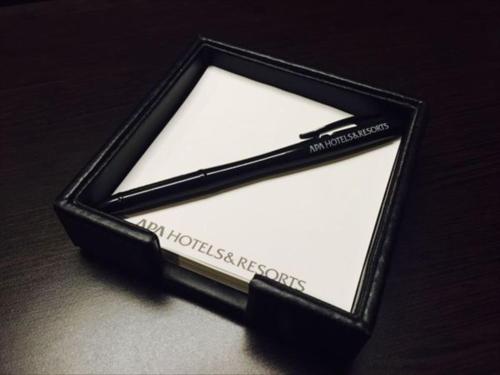 a black and whiteangular object with the words new horizonspoke on it at APA Hotel Isesaki-Eki Minami in Isesaki