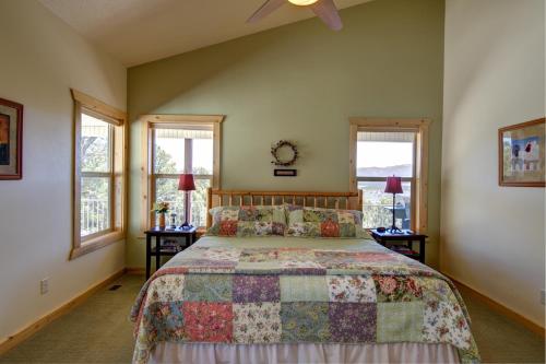 a bedroom with a bed and two windows at Ridgetop Hideaway in Hatch