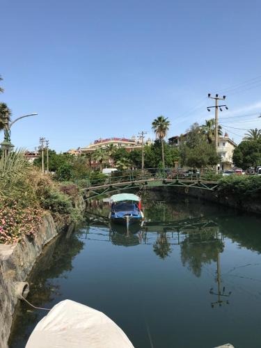 a boat is docked in a small canal at Blue Yacht Marina Apart Hotel in Marmaris