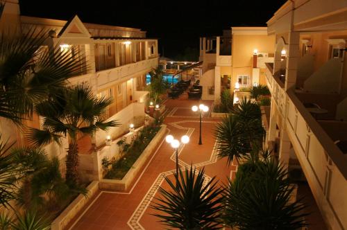 an overhead view of a courtyard at night with lights at Elektra Beach Hotel in Kalamaki Chanion