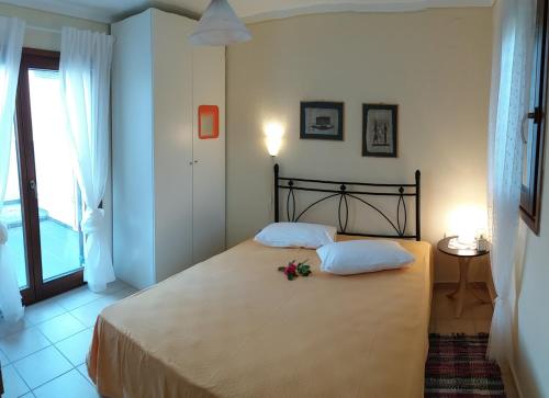 a bedroom with a bed with flowers on it at Evgenia Maisonette in Ierissos