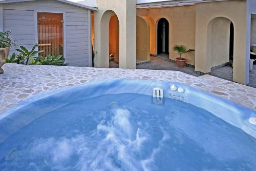 a swimming pool in front of a house at The Gomera Lounge in Valle Gran Rey