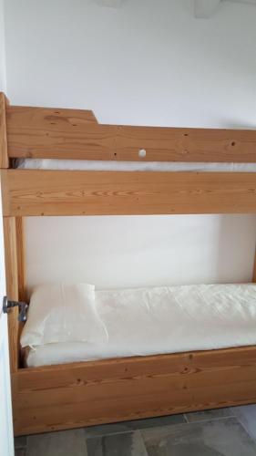 a wooden bunk bed in a room at Rocca d'Anfo B&B-Apartments Lake View in Rocca dʼAnfo