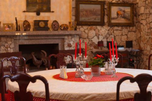 a dining room table with red candles on it at Dallas Residence Suites in Varna City