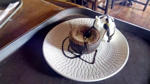 a chocolate doughnut on a plate on a table at Mansion Theodora in Makrinítsa