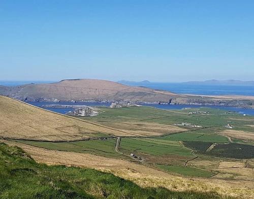 an aerial view of a field and a body of water at Skellig Port Accomodation - 2 Bed Apartment in Portmagee