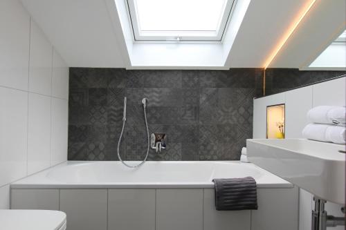 a bathroom with a sink and a bath tub at Haus Lukaswinkl in Schönau am Königssee