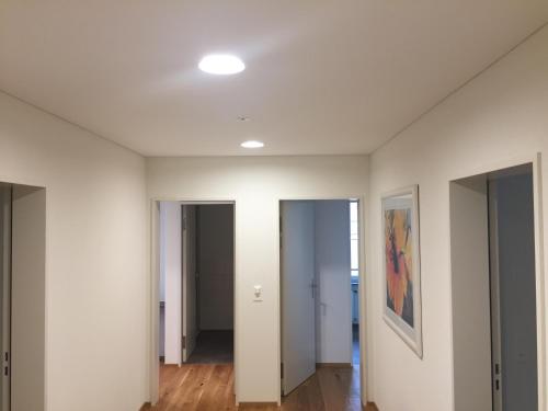 an empty room with white walls and wood floors at Gasthof National in Langendorf
