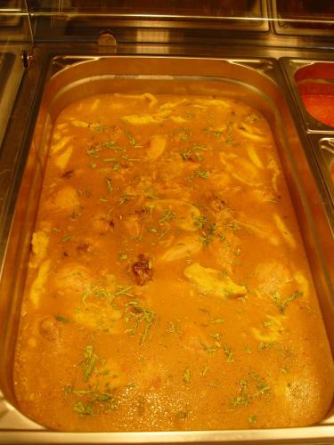 a pan filled with food in an oven at Hotel Astra in Braşov