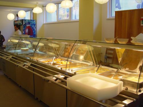 a buffet line of food in a restaurant at Hotel Astra in Braşov