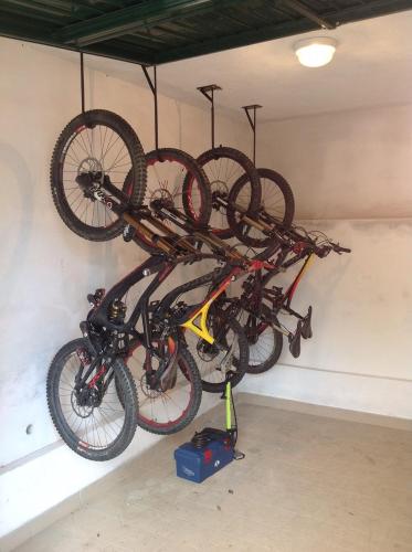 two bikes hanging on a wall in a garage at Hotel Europa in Finale Ligure