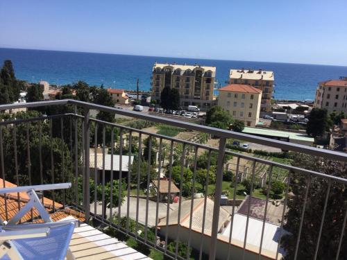 a balcony with a view of a city and the ocean at Hotel Europa in Finale Ligure