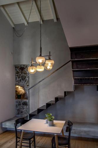 a dining room with a table and lights at Talè Restaurant & Suite in Piedimonte Etneo