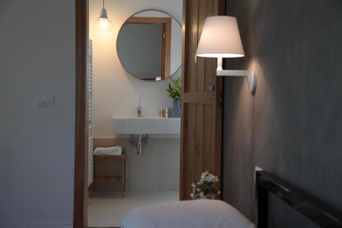a bathroom with a sink and a mirror at Talè Restaurant & Suite in Piedimonte Etneo