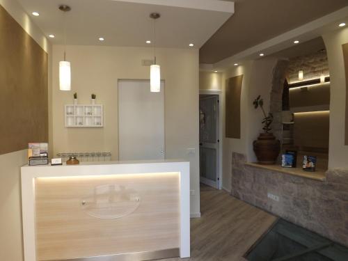 a lobby with a counter in a room at Camere Santa Chiara in Assisi