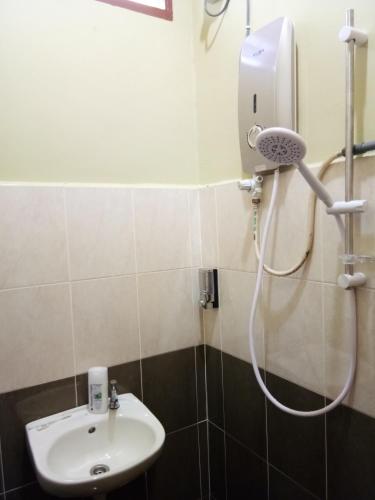 a bathroom with a shower and a sink at HR Iman Homestay in Dungun