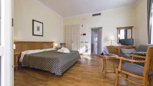 Postel nebo postele na pokoji v ubytování Hotel Ville Bianchi