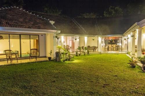 a house with a lawn in the yard at night at Garden Villa Ronnaduwa in Hikkaduwa