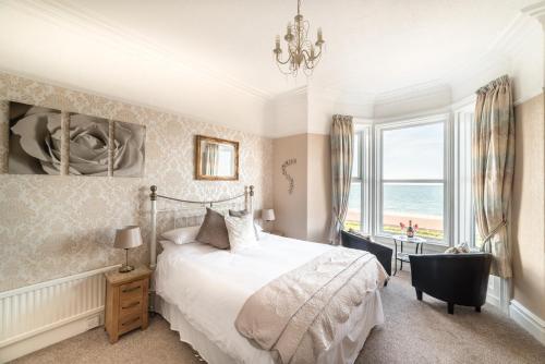 a bedroom with a bed and a large window at The Grafton Guest House in Llandudno