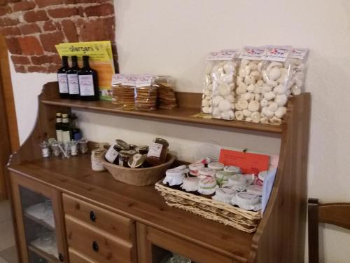 a wooden cabinet with bottles of wine on a shelf at Agriturismo Fior Di Campo in Dronero