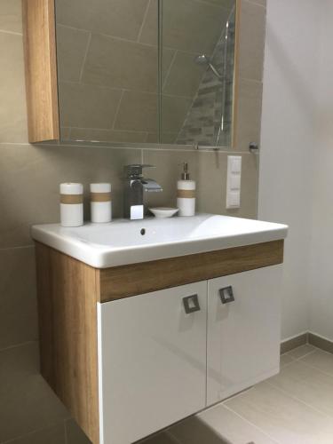 a bathroom with a white sink and a mirror at Enjoyit Rooms in Velden am Wörthersee