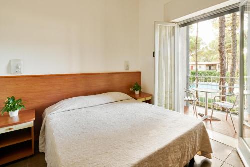 Postel nebo postele na pokoji v ubytování G/Hotel Lignano