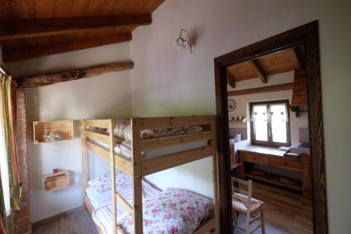 a bedroom with two bunk beds and a desk at Cascina Bricco in Ovada