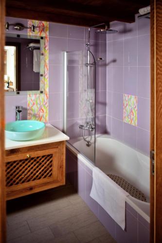 a bathroom with a sink and a tub and a shower at Bella's House in Évora
