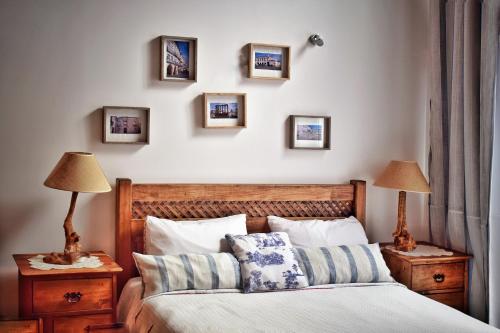 a bedroom with a bed and pictures on the wall at Bella's House in Évora