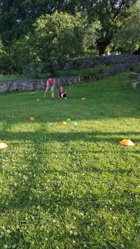 two people playing with kites in a field of grass at Green Silence - Vuk in Podgorica