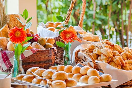 a table with baskets of bread and baskets of pastries at Hotel Obelisco in Cali