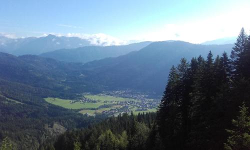 a view of a valley with mountains and a town at Ferienhof Alte Post, Apartments in Weissbriach