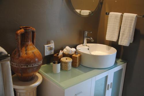 a bathroom with a sink and a vase on a counter at Off Broadway B & B in Denver