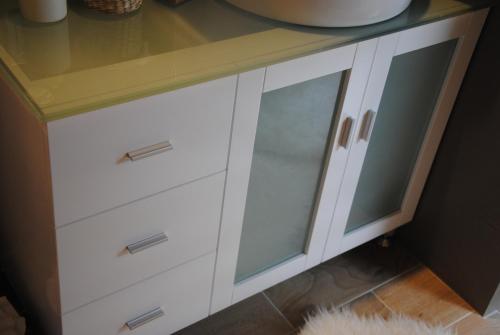 a white cabinet with glass doors in a kitchen at Off Broadway B & B in Denver