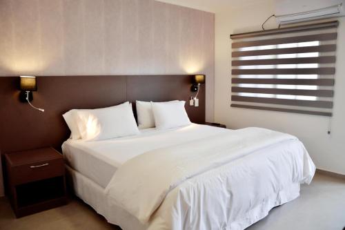 Una cama o camas en una habitación de Hotel Posada La Sorgente
