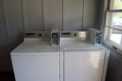 a small kitchen with a refrigerator and three appliances at St Croix Suites - St Croix Falls in Saint Croix Falls